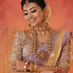 A close-up portrait of the model, showing how the custom blouse and traditional jewelry create a stunning bridal look.