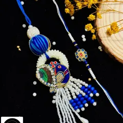 Celebrate the bond between your Bhaiya and Bhabhi with my coordinated Rakhi sets. This elegant peacock Lumba rakhi, paired with a matching thread for your brother, is a beautiful way to honor their relationship.