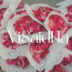 A close-up of the delicate paper cones filled with fresh rose petals. This is a simple yet beautiful detail that adds to the guest experience and looks wonderful in photos.