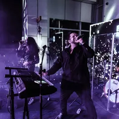 A shot of us performing on a professionally lit stage for a corporate event. We bring the full concert experience, complete with smoke and lights.