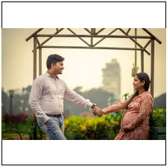 A quiet, romantic portrait of an expecting couple in a park setting. Holding hands and sharing a look, this photo captures the partnership at the heart of their growing family.