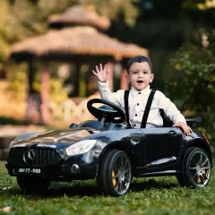 A happy wave from the driver's seat of a mini toy car during an outdoor park shoot. These sessions are full of natural smiles and playful energy.