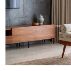 A close-up of the warm wood grain on a media console. We love using natural materials to bring warmth and organic texture into the homes we design.