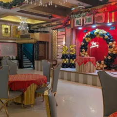 This wide shot shows how the stage decorations fit into the larger banquet hall. The setup commands attention on the stage while complementing the overall venue ambiance for a corporate celebration.