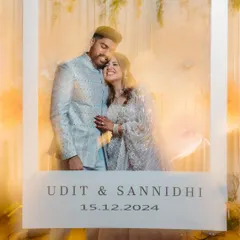 A creative and fun shot using a giant polaroid frame to capture the newly engaged couple. The motion blur and light trails add a magical, celebratory feel to their special moment.