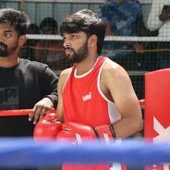A fighter and his cornerman between rounds. This moment of focus is critical for listening to instruction, catching your breath, and preparing for the next round.