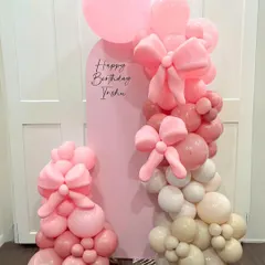 This coquette-themed setup showcases our skill in detailed balloon artistry. We hand-twisted multiple large and small pink bows and integrated them into an organic balloon garland, set against a custom pink arch backdrop for Trisha's birthday.