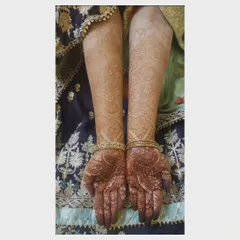 Here you can see the fully developed stain on both arms. My application ensures even color development, from the detailed work on the palms to the larger patterns on the forearms.
