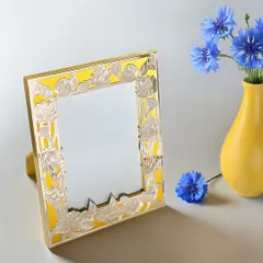 Stories deserve a frame as beautiful as the memories they hold. This frame features a bright yellow enamel border with a silver-plated floral overlay.