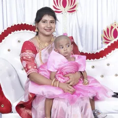 A mother and her child at a baby-related function. The mother's makeup is simple and elegant, perfect for a family-focused celebration.