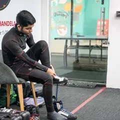 The preparation starts before an athlete even steps into the shooting lane. Here, a shooter gets into his specialized gear, a routine that helps build focus and readiness.