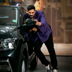 An indoor shot from the Volkswagen campaign with Ali Fazal. His dynamic pose and interaction with the car create a narrative of style and confidence.
