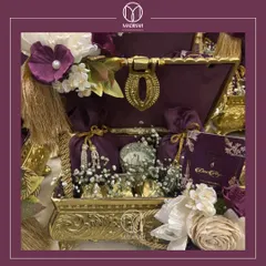 Here is the Rajwada Chest, a gift of timeless elegance fit for royalty. The deep purple velvet interior and ornate gold-finished exterior make it a truly luxurious wedding hamper.
