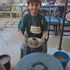 Look at that proud face. This young artist has just finished shaping his first pot on the wheel. My goal is for every child to leave with a sense of accomplishment and a masterpiece they're excited to show off.