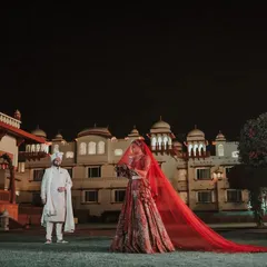 A breathtaking wide shot of the couple at their destination wedding, with the palace lit up against the night sky. This is the kind of epic, cinematic wedding photography I love to create.