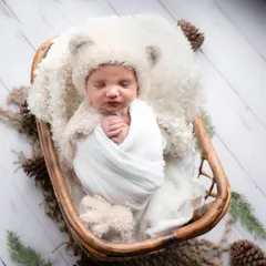 I just can't get enough of this little one. A simple, rustic setup with a cozy wrap and a soft teddy bear allows the baby's natural sweetness to shine through.