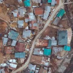 Perspective changes everything, especially from above. A top-down aerial view of a small village in Kashmir, showing the colourful rooftops.