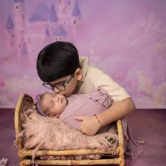 A fairytale beginning for these two. A protective older brother gives his new baby sister a gentle kiss, a promise of a lifetime of looking out for her.