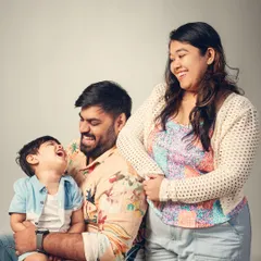 A moment of pure, unscripted laughter. Candid shots like this are often the most cherished, capturing the genuine joy and love within a family.