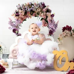 A wide shot of the lavender floral first birthday setup, complete with a "One" sign. I customize each birthday set to match your vision and color scheme.