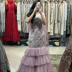 A mirror selfie showing off the full look of our lavender gown. You can see the beautiful floral embroidery and the elegant cape-style dupatta.
