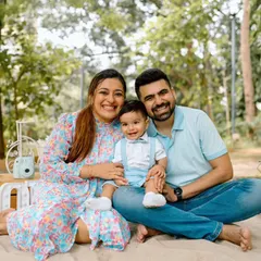 An outdoor family picnic session is the perfect way to capture genuine smiles. Here, we used the soft afternoon light in a Mumbai park to create a warm, relaxed portrait of this beautiful family of three.