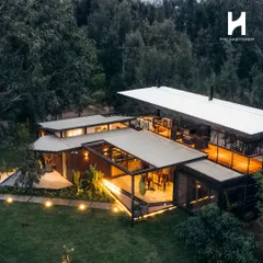 This aerial view showcases a 2BHK cargo home we built, demonstrating how multiple container units can be seamlessly integrated into a larger, cohesive design. The layout includes expansive decks and thoughtful landscaping, creating a complete hospitality experience that feels both private and connected to nature.