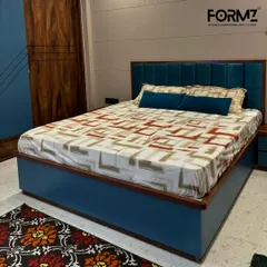 I designed this bed with a vibrant teal upholstered frame and a vertically paneled headboard for a touch of color. The design is complemented by wood accents, demonstrating how I blend different materials for a cohesive and modern look.