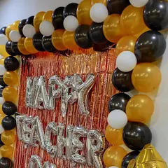 A close-up view of the Teacher's Day balloon wall. The combination of a shimmering backdrop, bold foil letters, and a classic color palette of gold, black, and white creates a professional and celebratory look.