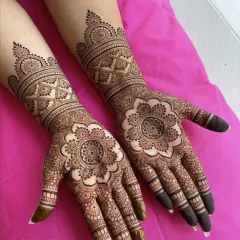 A clean and elegant design featuring a large mandala on the palm and matching patterns on the arm. This is a perfect example of modern minimalism.