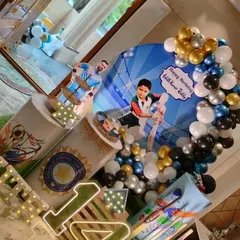 A high-angle shot of the cricket decor, highlighting the personalized backdrop with the birthday boy's photo.