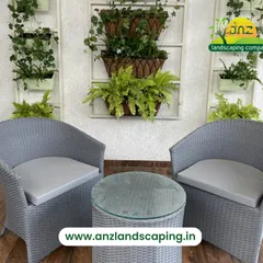 This cozy balcony seating area is framed by creative wall planters. We used a combination of hanging baskets and wall-mounted frames to create a multi-level green display.