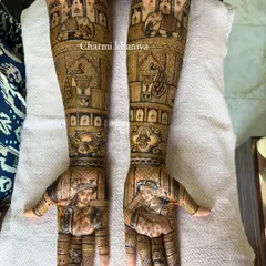 A breathtakingly detailed bridal mehendi that extends up the arms. This design features portraits, palace scenes, and royal elephants, making it a true work of art for the bride's special day.