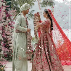 The jaimala ceremony at a stunning lakeside wedding in Naukuchiatal, with flower petals showering the couple.