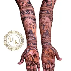 I love the challenge of creating detailed, multi-figure portraits in my mehandi designs. This piece shows different scenes and people, telling a rich story on the bride's arms.