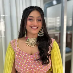 This client is glowing with happiness. I used soft pink and champagne tones on her eyes and a dewy foundation to give her a fresh, youthful radiance for the wedding function.