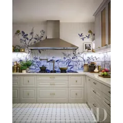 This kitchen, featured in Architectural Digest, is one of my favorites. We used custom hand-painted tiles to create a beautiful, classic blue and white floral design, blending it with modern shaker cabinets and a stainless steel chimney for a timeless look.