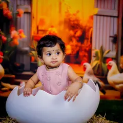 A different angle of our popular eggshell prop in the farmyard setting. The warm lighting and rustic details make this a unique and charming choice for a baby photoshoot.