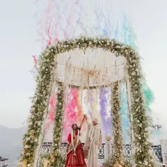 A spectacular wedding scene with the groom standing tall in our bespoke ivory sherwani. The complete look, including the coordinated safa and stole, is designed to be grand yet elegant.
