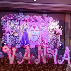 A Barbie and Rapunzel theme party fit for a princess. I designed this grand stage with a sequin wall, large character cutouts, custom name lettering, and a pink and purple balloon arrangement for Vanya's 9th birthday.