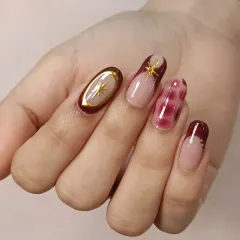 This angle showcases the elegant oval shape of the nails and the balance of the different designs, from the simple French tip to the more intricate accent nails.