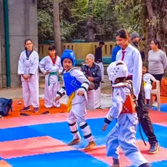 Students get ready to compete at the 2nd Delhi Open Taekwondo Championship, showing focus and readiness.