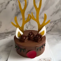 This adorable reindeer cake is a highlight of my Christmas collection. It's a rich chocolate cake decorated with ganache and cute antlers, perfect for adding a touch of whimsy to your holiday table.