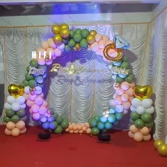 For your ring ceremony, I can create a beautiful and symbolic backdrop. This setup uses a circular balloon arch in olive green and peach, accented with a large diamond ring foil balloon and custom lettering for the couple's names, making the moment picture perfect.