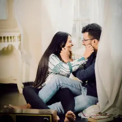 A cozy and playful indoor moment. Sitting on the floor, surrounded by soft curtains, this shot captures the simple, everyday love that is so special.