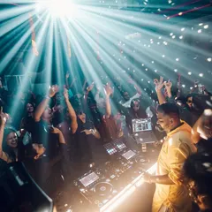 A beam of light cuts through the club as I control the dancefloor. This shot captures the pure energy of a packed club night.
