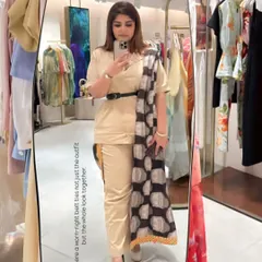 This fusion officewear look is all about the details. A simple beige co-ord set is elevated with a patterned dupatta, a waist-cinching belt, and timeless accessories.