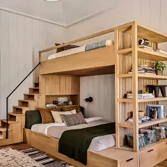 For this kids' bedroom, I focused on creating a fun, space-saving environment. This custom wooden bunk bed includes stairs that double as storage drawers, making the most of a compact room while adding a playful touch.