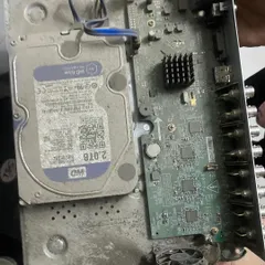 This is the inside of a poorly maintained DVR. The buildup of dust and dirt on the hard drive and motherboard can lead to overheating and complete system failure.