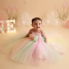Happy First Birthday to this little ray of sunshine. Her joyful laugh and the pastel rainbow dress make this a perfect cake smash alternative for a one-year-old's photoshoot.